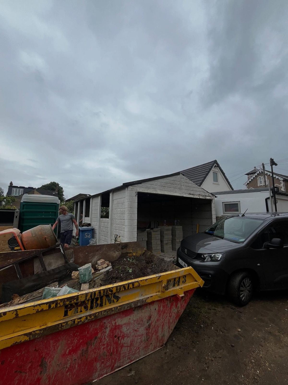 Skip and van on site during demolition
