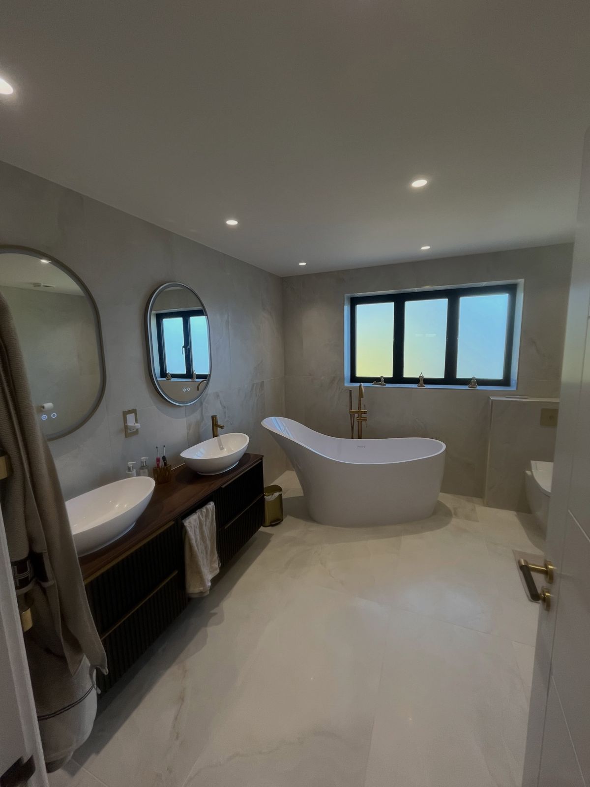 Large en-suite with freestanding bath and twin basins